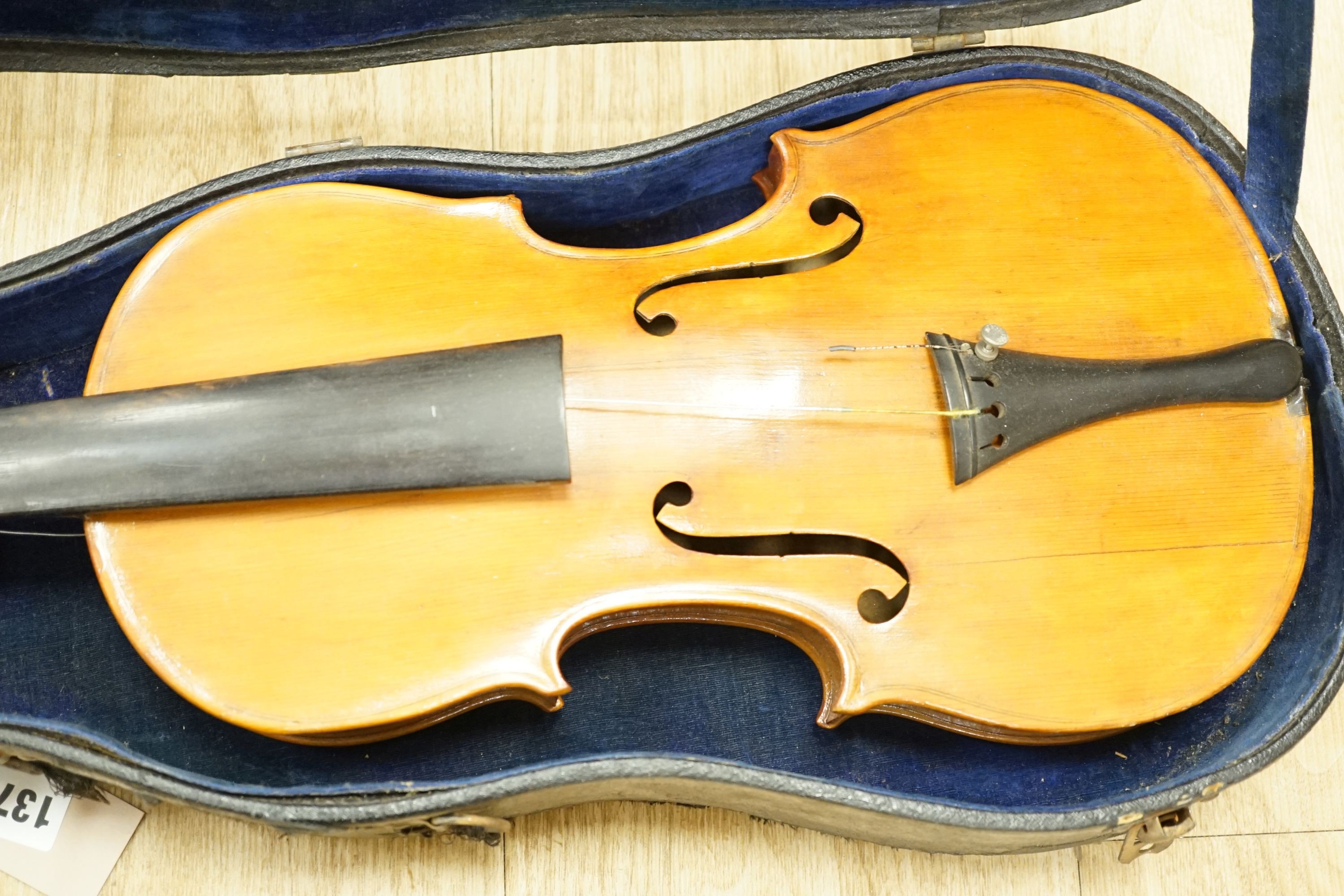 A cased violin, 60 cms long.